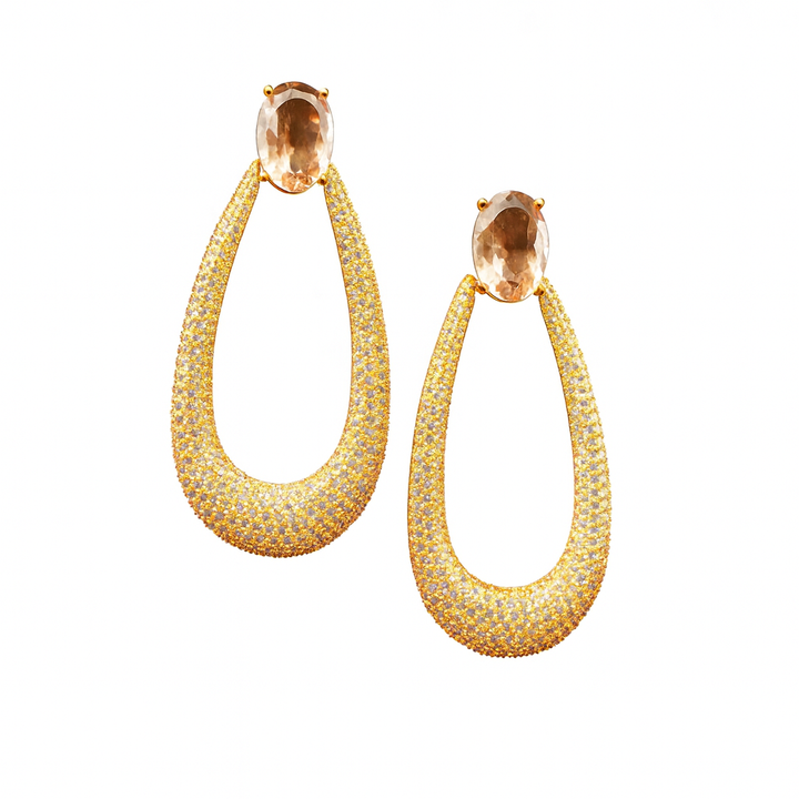 Long gold-colored drop earrings with zirconia