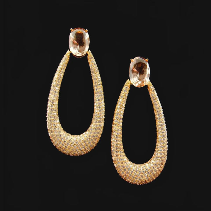 Long gold-colored drop earrings with zirconia