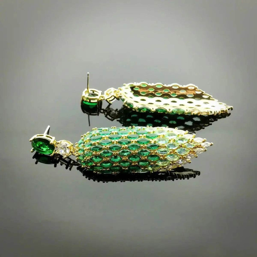 Gold-colored leaf earrings with green zirconia
