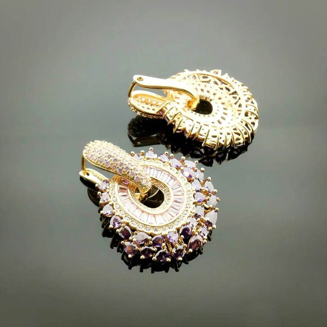 Rose gold-colored earrings with pink zirconias