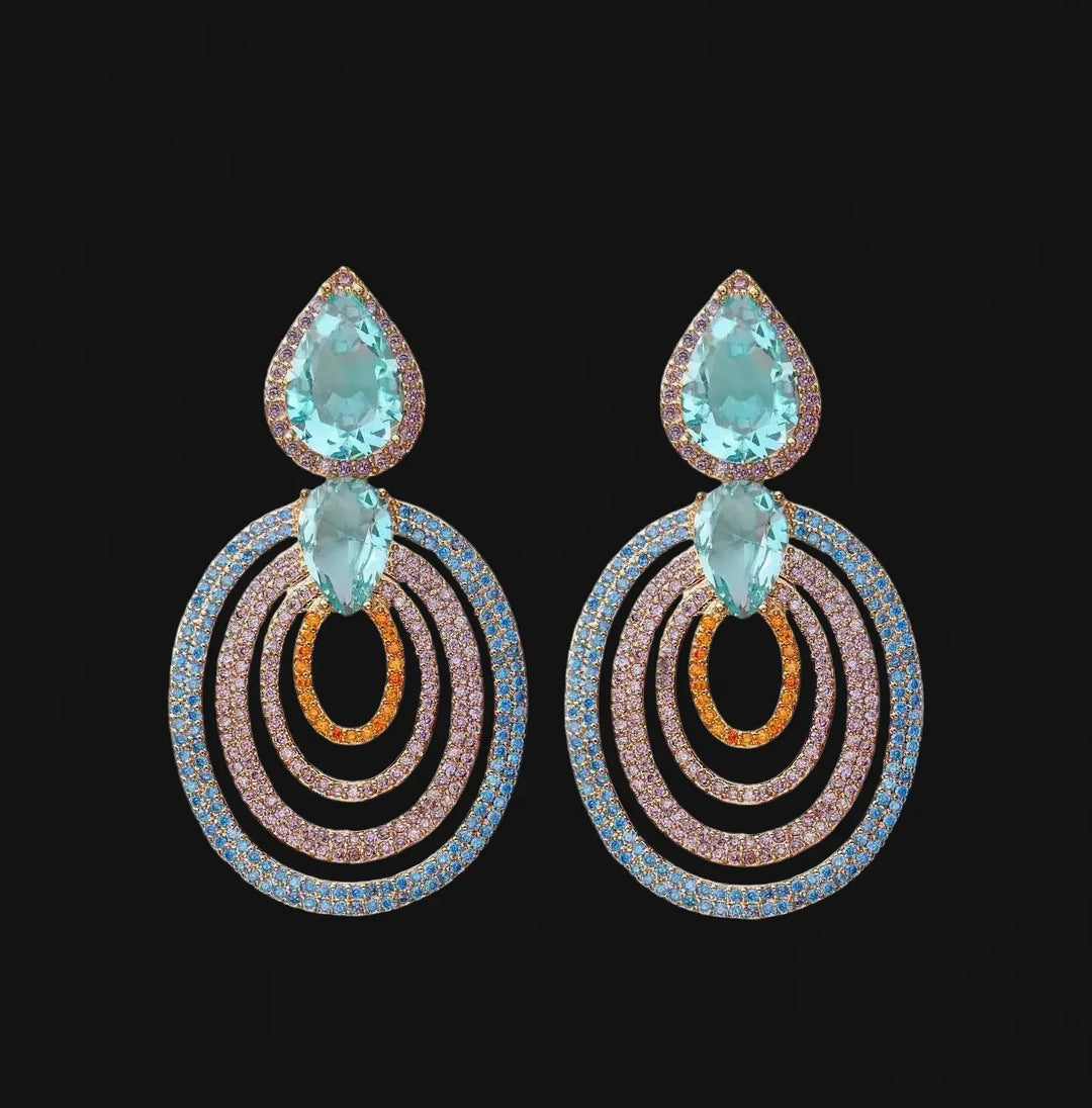 Rose gold colored earrings with turquoise colored zirconias