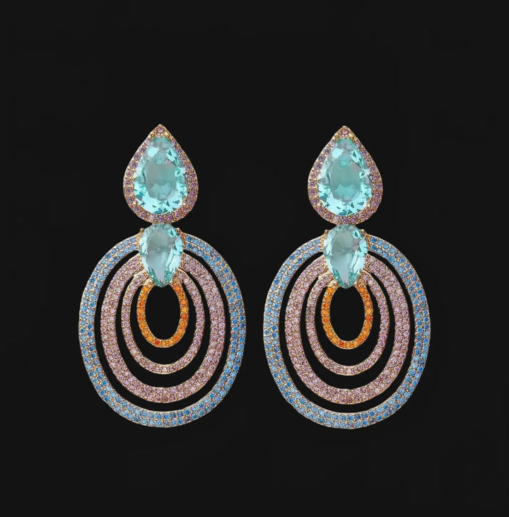 Rose gold colored earrings with turquoise colored zirconias